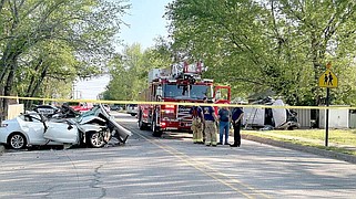 First responders investigate the seen of a head-on collision in which three people died Thursday on Broyles Street in Farmington.
(NWA Democrat-Gazette/Lynn Kutter)